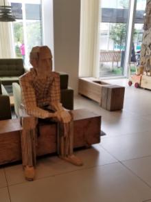 Iceland hotel wooden statue man sitting